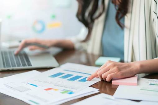 A person pointing at a graph on a paper
AI-generated content may be incorrect.